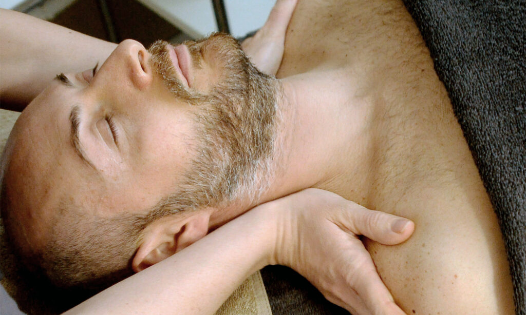 Gentleman receiving neck treatment during mens facial 